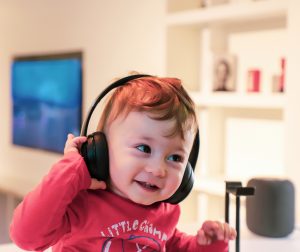 child listening to music on headphones